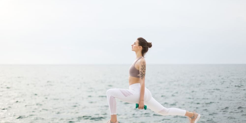 chica haciendo ejercicios pesas yoga